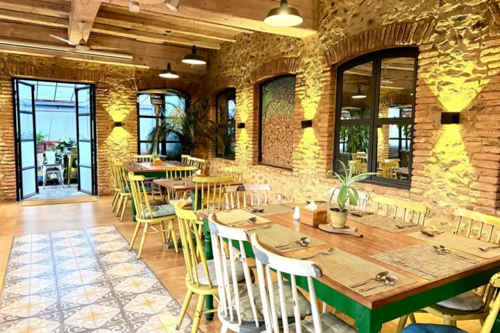 Loft dining space with exposed brick, arched windows and pendant lights