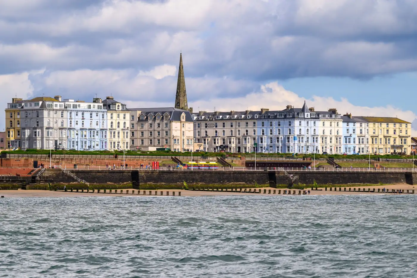 Seafront terrace of pastel townhouses seen from the water