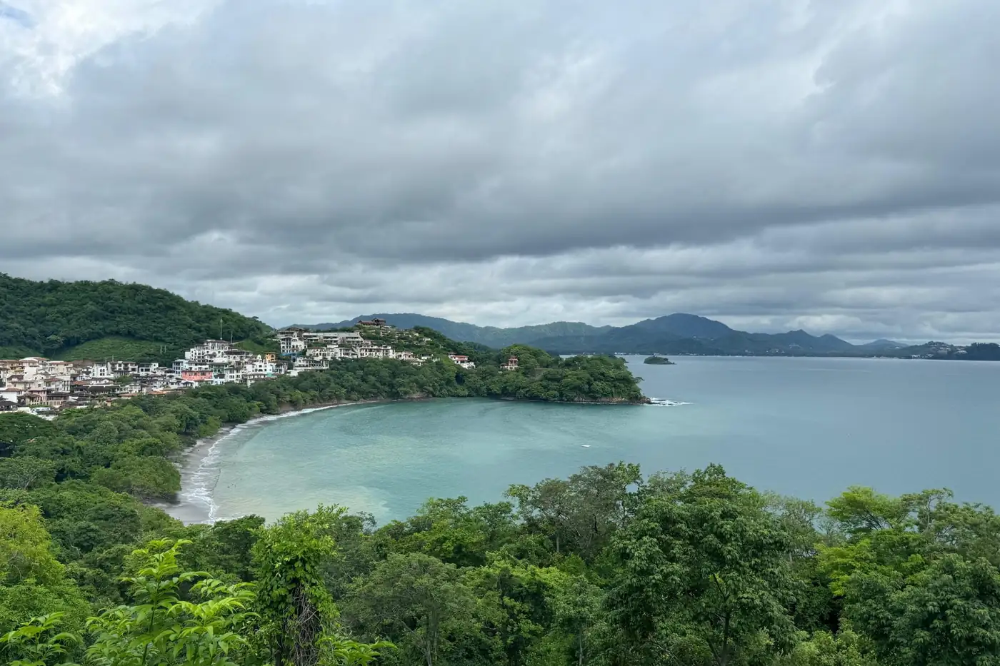 Crescent bay seen from forested hills